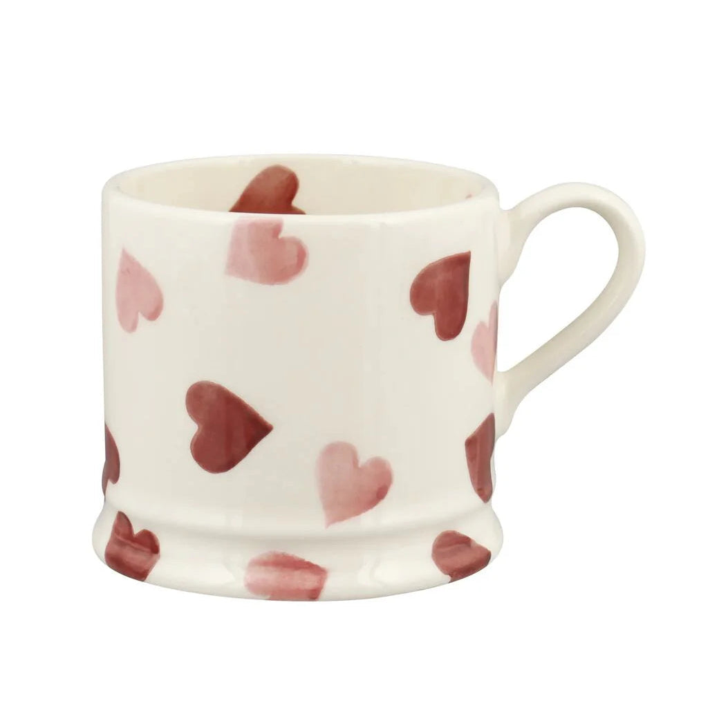 White mug with red heart pattern on a white background
