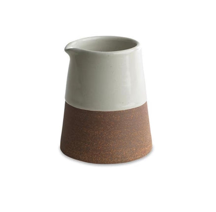 Ceramic pitcher with two-tone design on a white background