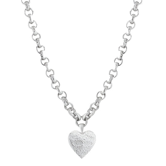 A silver necklace with a heart-shaped pendant on a chunky chain, with a textured and brushed finish on the pendant.
