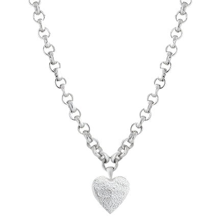 A silver necklace with a heart-shaped pendant on a chunky chain, with a textured and brushed finish on the pendant.