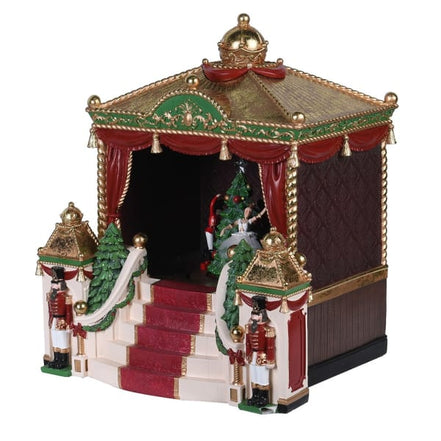 Decorative Christmas gazebo with red curtains, gold accents, and Nutcracker figures on a white background.
